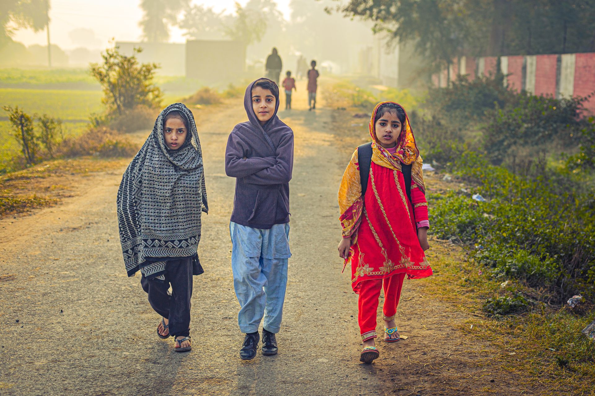 Children walking on a rural path in Punjab, Pakistan